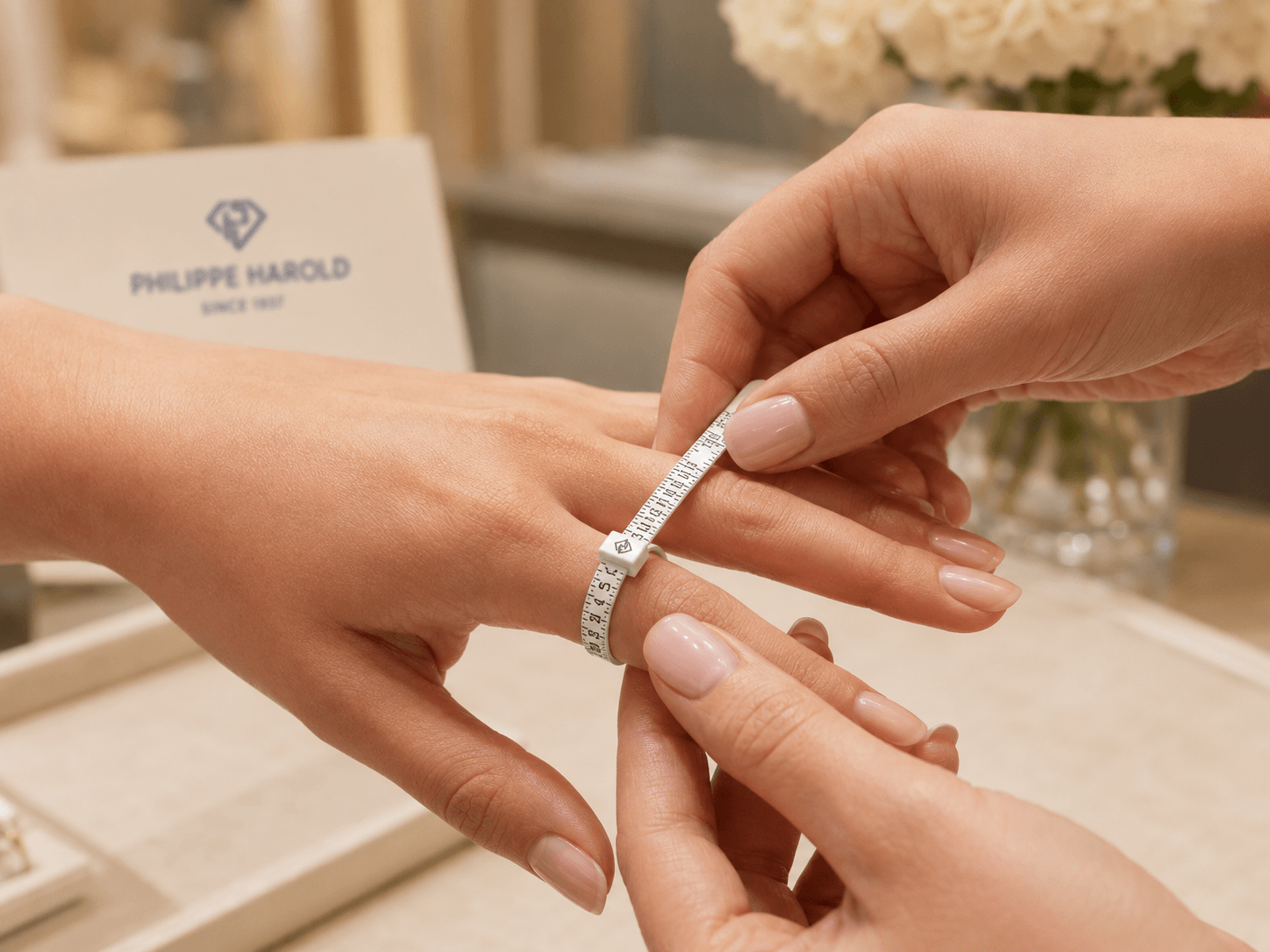 Wrapping a paper strip around a finger to measure ring size